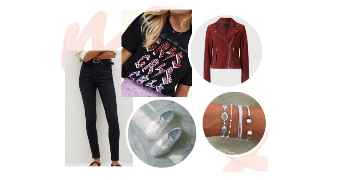 Black skinny jeans with a slogan graphic T-shirt, a burgundy suede biker jacket, white trainers and silver gemstone bracelets