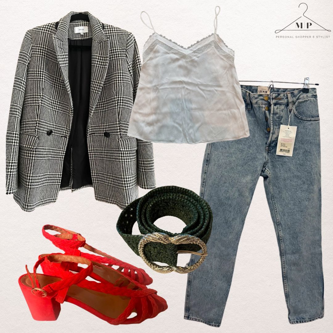 Black and white houndstooth blazer with a cream lace-trimmed camisole, light-wash mom jeans, a green woven belt with a gold buckle and red suede sandals