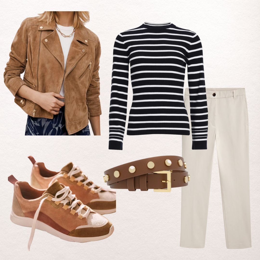 Tan suede biker jacket with a navy and white striped jumper, cream straight-leg trousers, a studded tan belt and rust suede trainers
