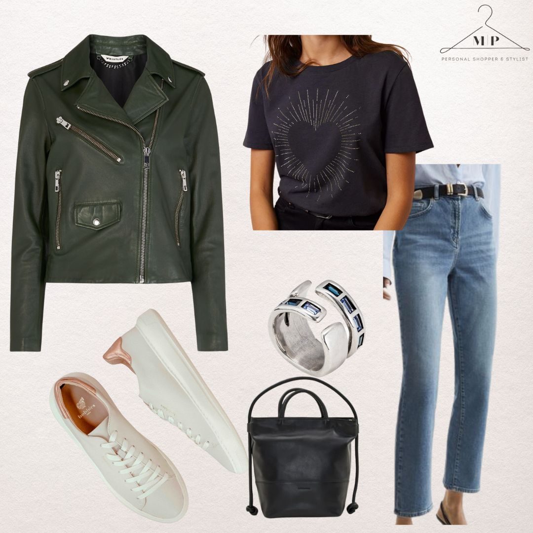 Olive green leather biker jacket with a navy heart-print T-shirt, straight blue jeans, a black leather bucket bag, a crystal statement ring and white platform trainers
